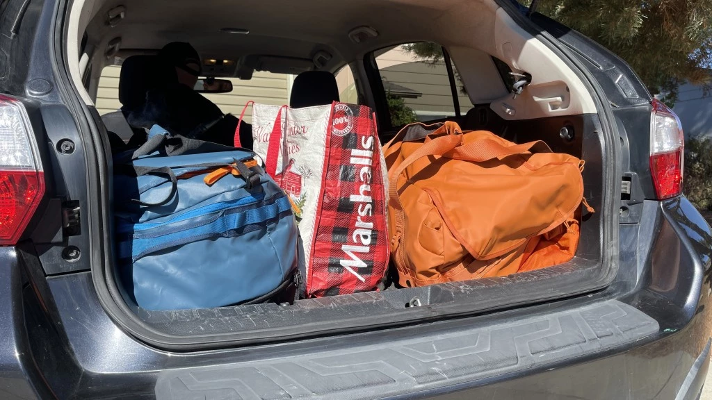 duffel bag - the cotopaxi allpa duo (blue, left) and thule chasm (orange, right)...