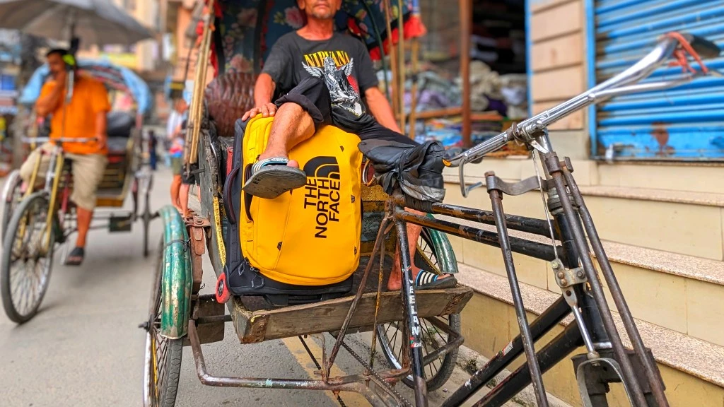 carry on luggage - a nepalese rickshaw driver chillin' with our the north face base...